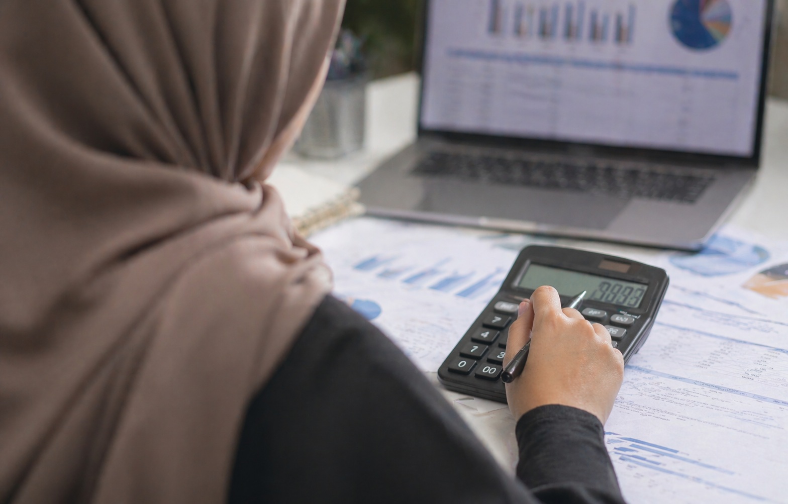 Woman using calculator